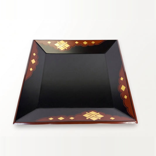 Tray viewed almost straight on, raised slightly, its inner rim visible within the red-brown, gold-diamond border.
