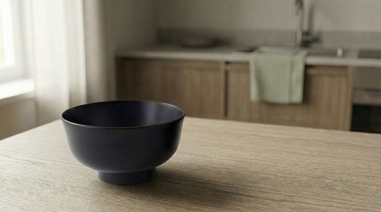 Plain black Joboji lacquerware bowl on a European kitchen table — true luxury is purity of material