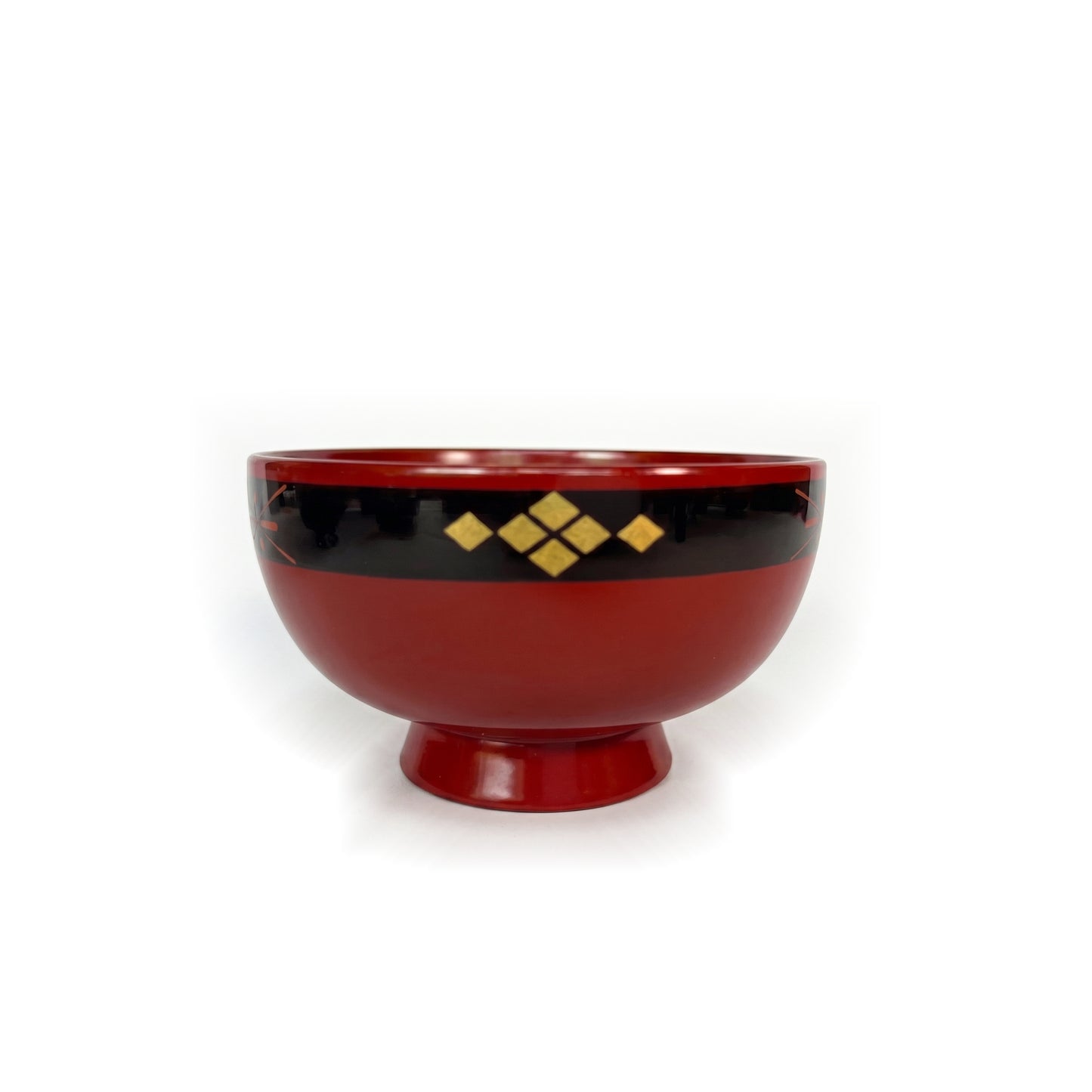 A red lacquer bowl on a high foot, with six gold-leaf diamonds centered on its black rim band.