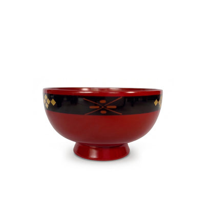 A red lacquer bowl on a high foot, with an orange cross-and-dot motif on its black rim band and gold diamonds at the edges.