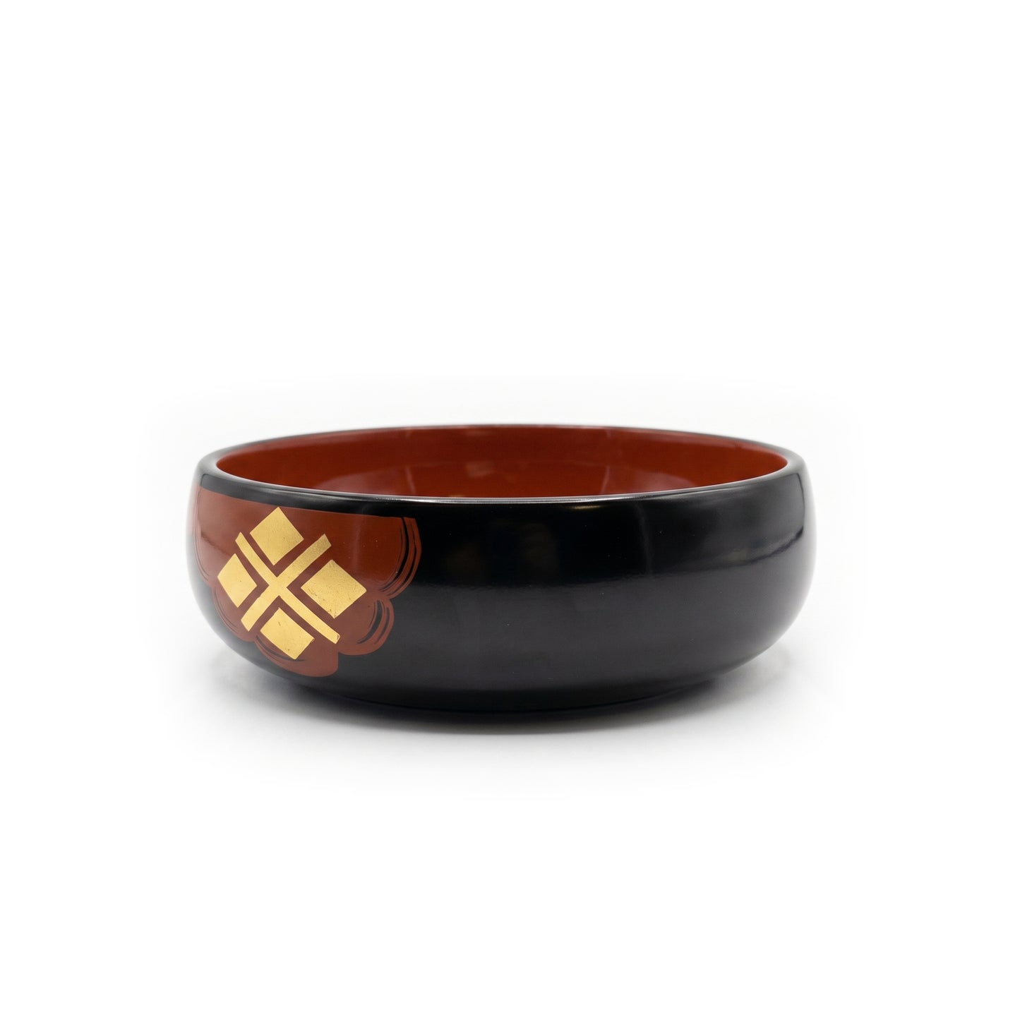 The bowl from a raised angle, its deep red interior open to view, with a gold four-diamond cross on a red patch at the left.