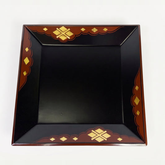 Square black lacquer tray shot from above, its red-brown cloud-shaped border set with gold-leaf diamonds on all four sides.