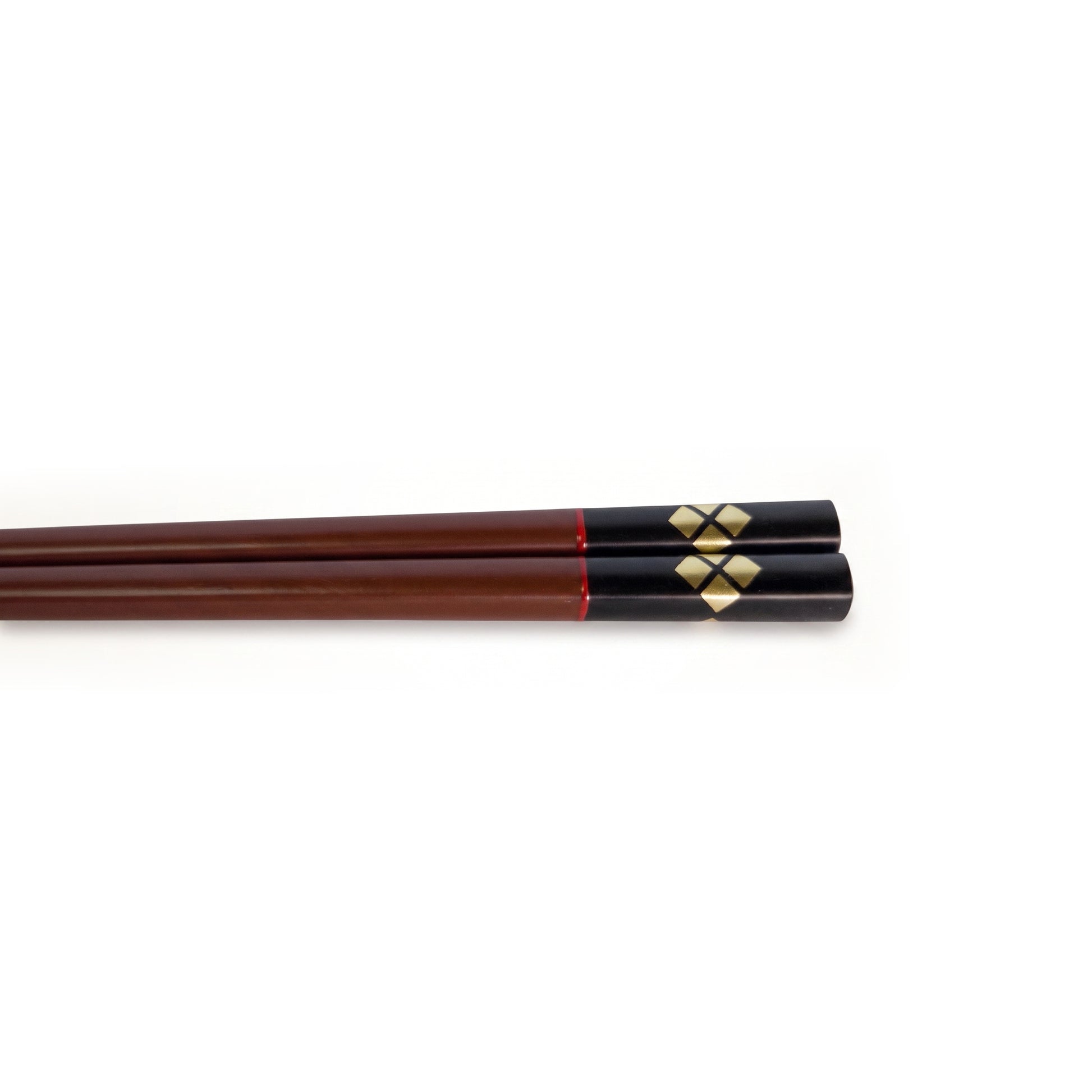 Close view of the bengara pair's handles, gold diamonds set around a dark cross on black lacquer.