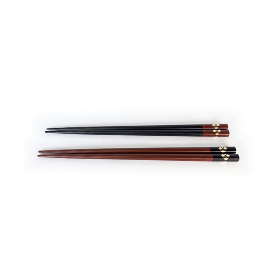 The two pairs laid flat one above the other, black above bengara, with gold at the head of each.