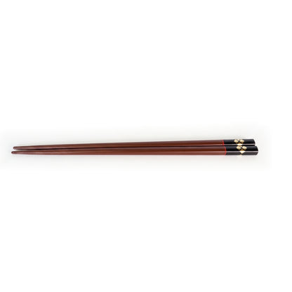 The bengara pair, the handle end finished in black lacquer with gold diamonds, a thin red line where the two meet.