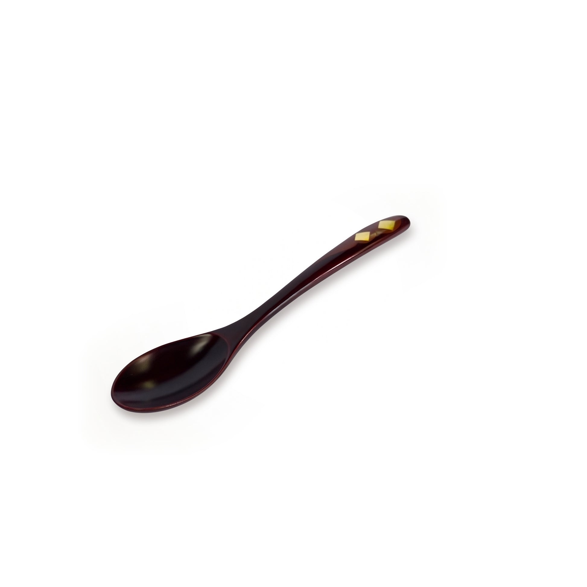 The maroon spoon alone on a diagonal, bowl at the lower left, two gold diamonds set near the raised tip of its handle.