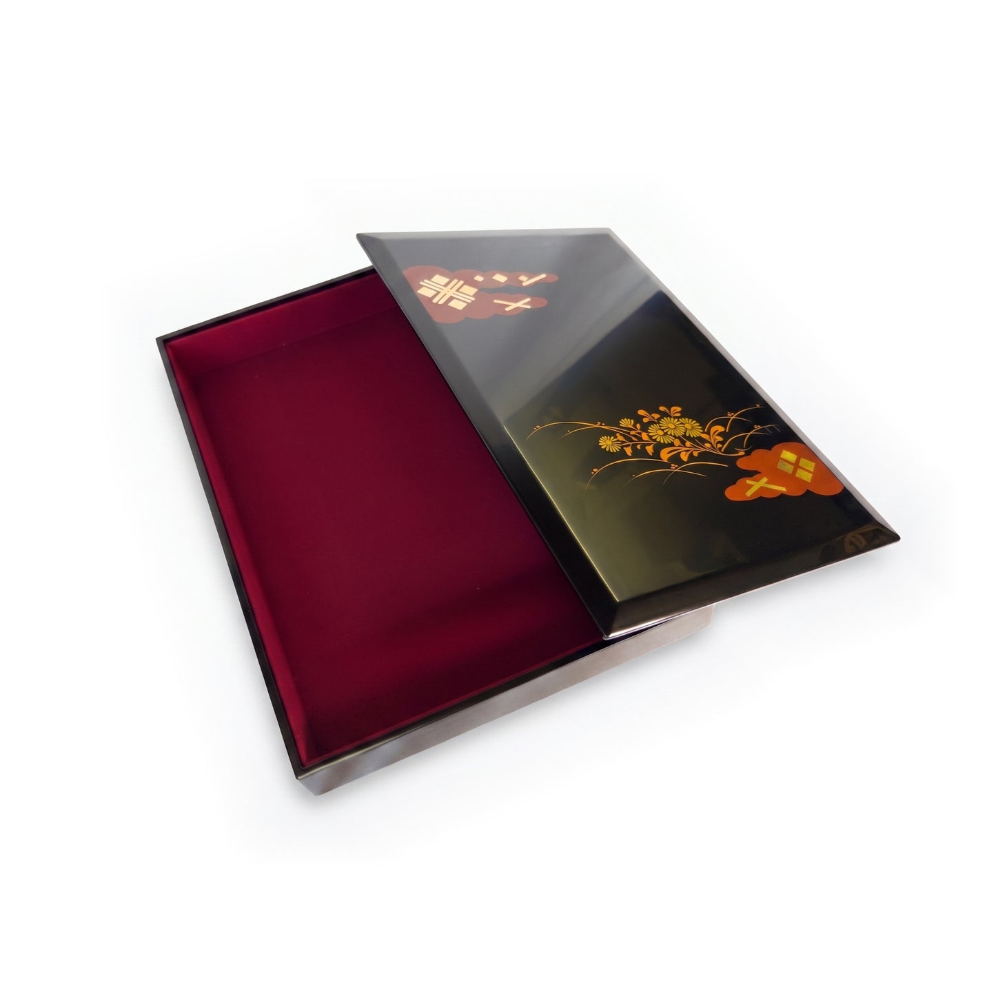 The box open, the lid resting to the right and the deep red cloth-lined interior fully exposed.
