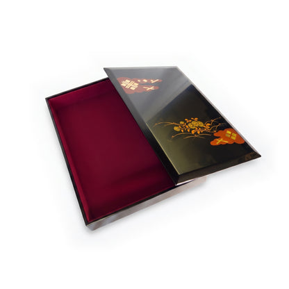 The box open, the lid resting to the right and the deep red cloth-lined interior fully exposed.
